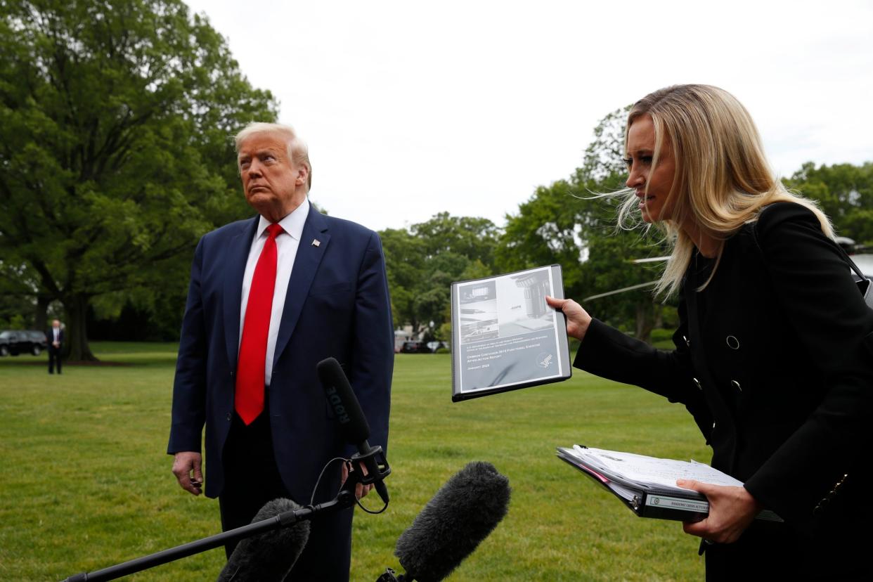 Donald Trump looks on as his press secretary Kayleigh McEnany speaks to reporters at the White House: AP