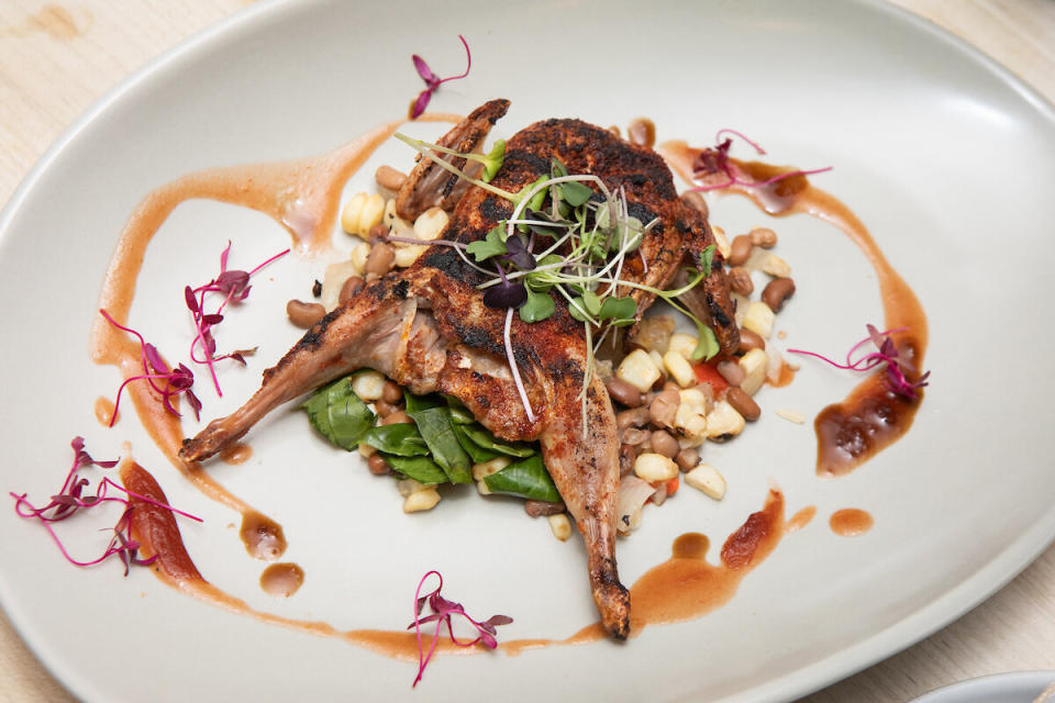 Barbecued quail with smoked watermelon-tomato pur&eacute;e, roasted corn, Sea Island pea succotash and pickled collard greens. (Photo: Clay Williams)