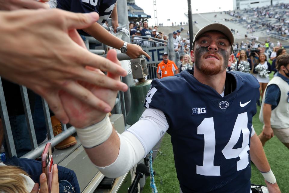 Sep 25, 2021; University Park, Pennsylvania, USA; Penn State Nittany Lions quarterback Sean Clifford (14) shakes the hands of members of the Penn State student section following the completion of the game against the Villanova Wildcats at Beaver Stadium. Penn State defeated Villanova 38-17. Mandatory Credit: Matthew OHaren-USA TODAY Sports