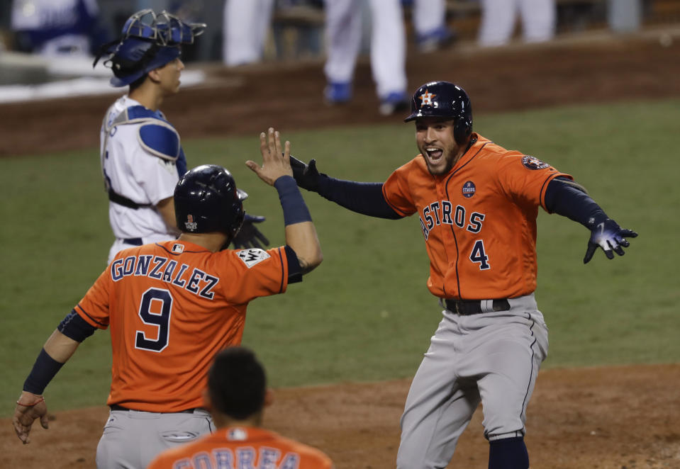 The Astros’ George Springer (4) celebrates after his two-run home run against the Dodgers on Wednesday night. (AP)