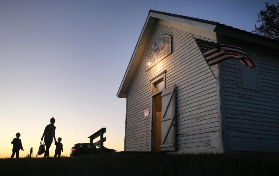 People enters a polling place at Sherman Township Hall, a former one room schoolhouse, in Zearing, Iowa.