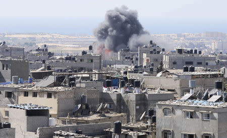 Smoke and flames are seen following what Palestinian witnesses said was an Israeli air strike in Rafah in the southern Gaza Strip July 10, 2014. REUTERS/Ibraheem Abu Mustafa