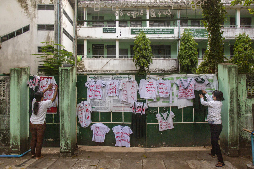 Activists and anti-coup protesters hang student uniforms on the wall of a school during a demonstration against the re-opening of the school by the government in Yangon, Myanmar, Tuesday, April 27, 2021. Demonstrations have continued in many parts of the country since Saturday's meeting of leaders from the Association of Southeast Asian Nations, as have arrests and beatings by security forces despite an apparent agreement by junta leader Senior Gen. Min Aung Hlaing to end the violence. (AP Photo)