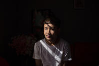 Bawi UK, 22, is photographed in his apartment in Providence, R.I., Saturday, Sept. 26, 2020. UK was a small child when his parents fled Myanmar, leaving him and his siblings to be cared for by their maternal grandmother. UK said the family suffered discrimination as Christians in a predominantly Buddhist nation. The military government was also trying to forcibly conscript his father. "To run for office, you had to be a Buddhist; to rent a house, you had to be Buddhist," said UK, a social work student at Rhode Island College and a youth leader at the Refugee Dream Center, an advocacy organization in Providence. (AP Photo/David Goldman)