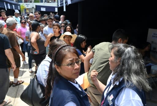 Voters queue at a polling station during legislative elections in Lima, on January 26, 2020