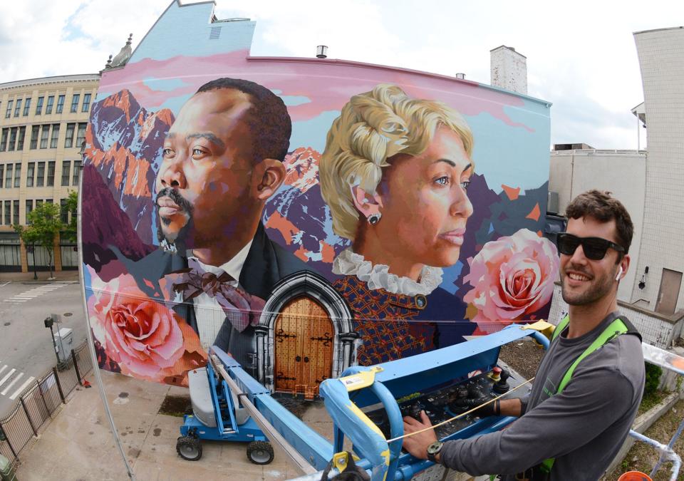 Mural artist Ben Keller, of Vernon, in front of his 50-by-60-foot mural at Castle Church in downtown Norwich. The mural features two important Black figures in Norwich’s history: James Lindsey Smith and Sarah Harris Fayerweather.