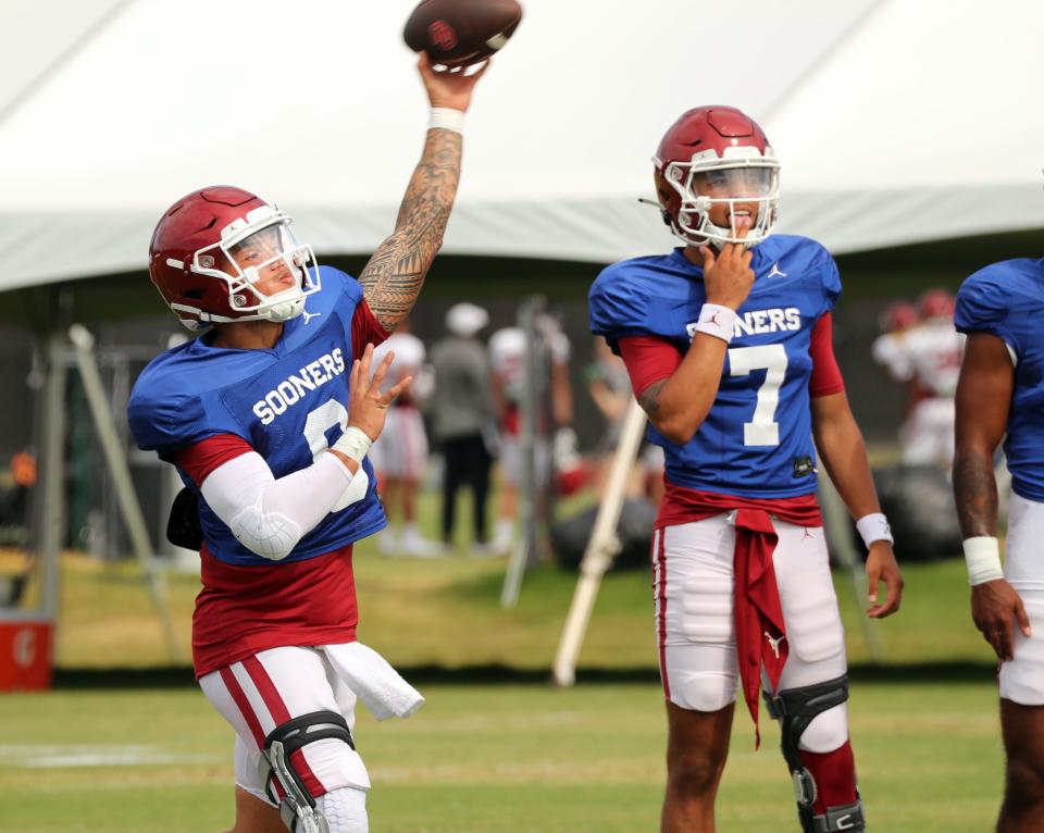 OU quarterback Dillion Gabriel, left, throws a pass during a recent practice.