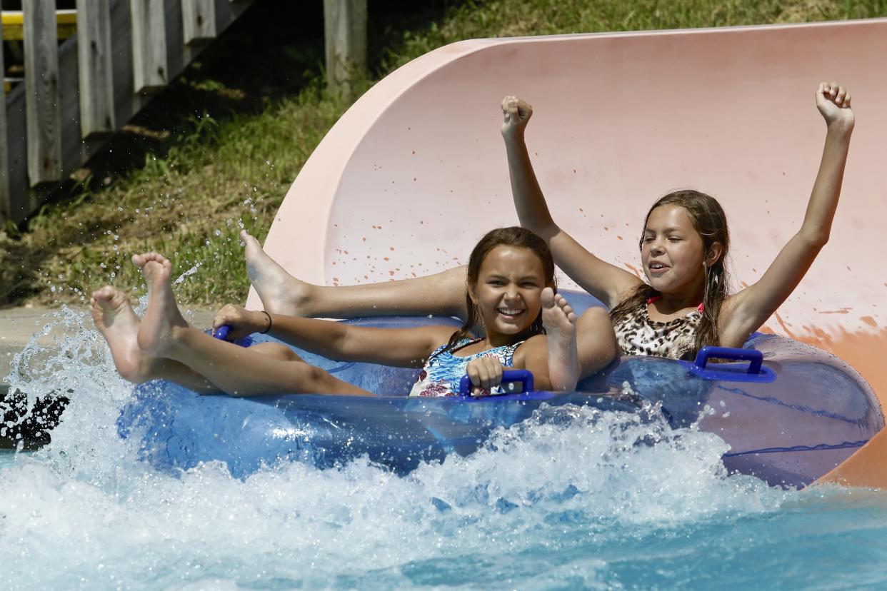 Season ticket holders ride in tubes down slides at Six Flags Hurricane Harbor in Rockford.