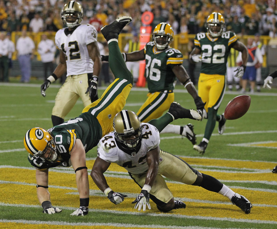 GREEN BAY, WI - SEPTEMBER 08: A.J. Hawk #50 of the Green Bay Packers is called for pass interference on Darren Sproles #43 of the New Orleans Saints on the final play of the game during the NFL opening season game at Lambeau Field on September 8, 2011 in Green Bay, Wisconsin. The Packers defeated the Saints 42-34. (Photo by Jonathan Daniel/Getty Images)