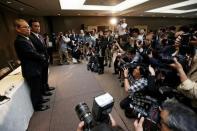 Toshiba Corp incoming President and chief executive Satoshi Tsunakawa (L) and incoming chairman Shigenori Shiga (2nd L) pose for a photograph at a news conference at the company headquarters in Tokyo, Japan May 6, 2016. REUTERS/Issei Kato