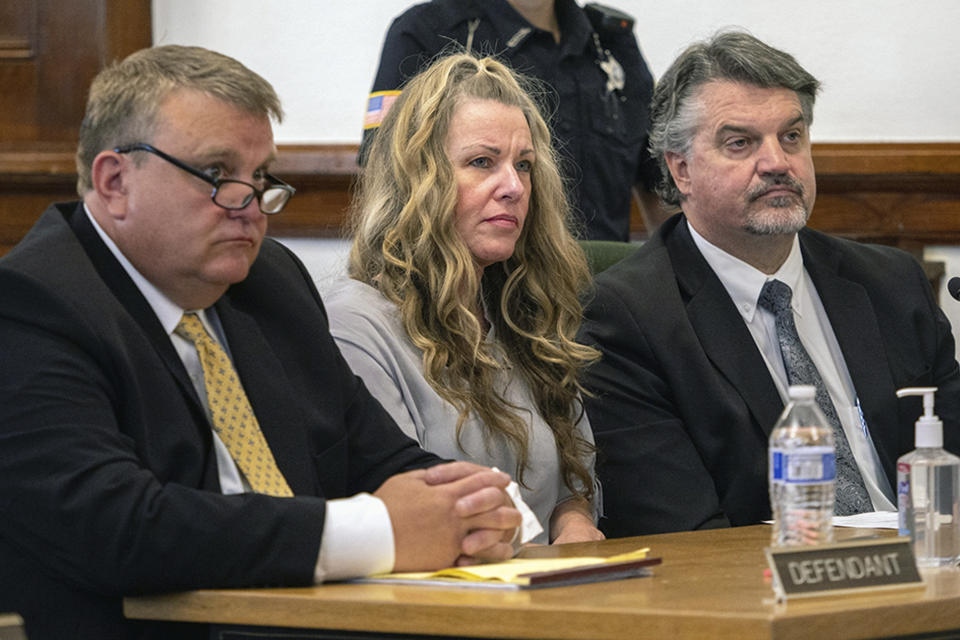 Lori Vallow Daybell sits between her attorneys for a hearing at the Fremont County Courthouse in St. Anthony, Idaho, Tuesday, Aug. 16, 2022. Attorneys for a mom charged with conspiring to kill her children and then steal their social security benefits asked a judge on Tuesday to send the case back to a grand jury because they say the current indictment is confusing. Lori Vallow Daybell and her husband Chad Daybell have pleaded not guilty and could face the death penalty if convicted. (Tony Blakeslee/East Idaho News via AP, Pool)