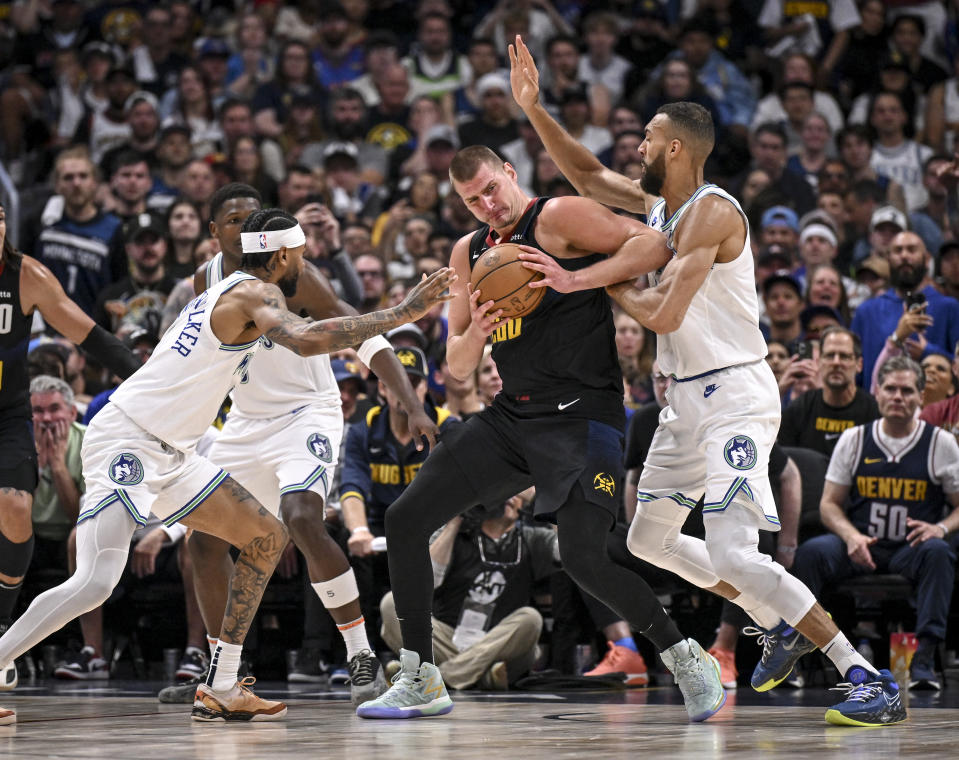 DENVER, CO - MAY 19: Nikola Jokic (15) of the Denver Nuggets steamrolls Rudy Gobert (27) of the Minnesota Timberwolves en route to scoring an easy basket during the second quarter at Ball Arena in Denver on Sunday, May 19, 2024. (Photo by AAron Ontiveroz/The Denver Post)