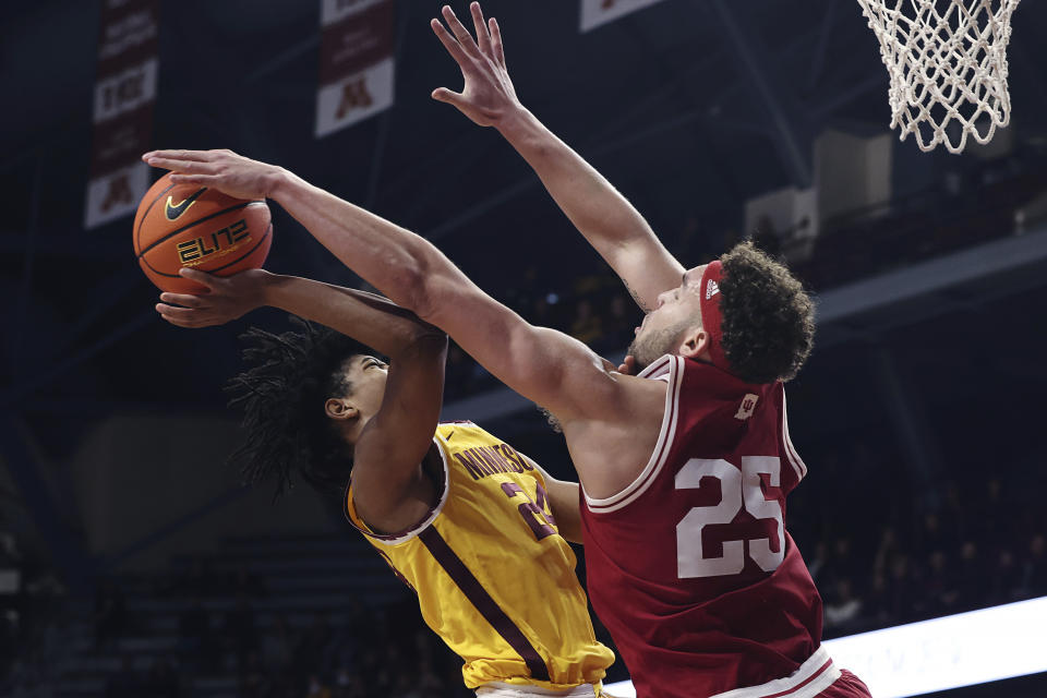 Minnesota forward Jaden Henley (24) tries to shoot against Indiana forward Race Thompson (25) during the first half of an NCAA college basketball game Wednesday, Jan. 25, 2023, in Minneapolis. (AP Photo/Stacy Bengs)