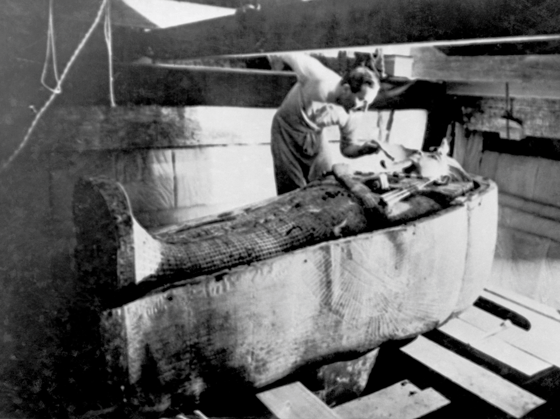 An archaeologist looks at a sarcophagus found in the tomb of King Tutankhamen in the 1920s.