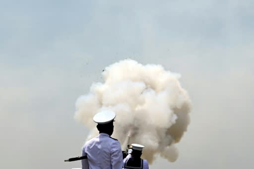 Sri Lankan Navy personnel fire a 21-gun salute to mark the island nation's 72nd Independence Day