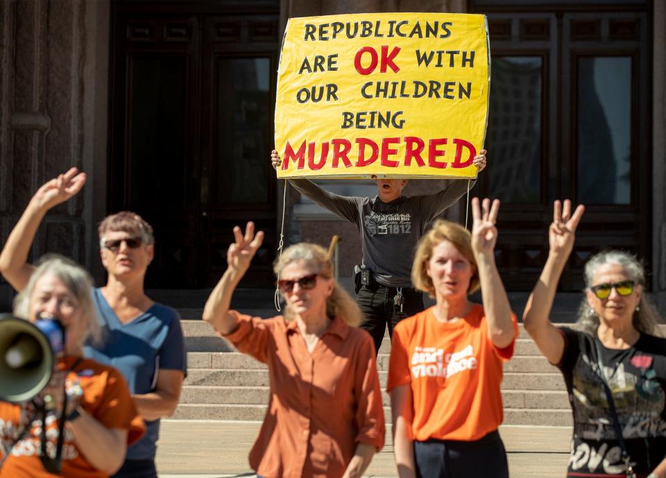 Gordon Jones hold a sign at a protest at the Capitol on Wednesday May 25, 2022, after a mass shooting at an elementary school in Uvalde.  