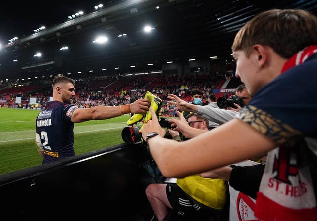 St Helens’ Tommy Makinson gives his boots to a fan