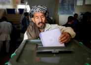 An Afghan man casts his vote during the parliamentary election at a polling station in Kabul, Afghanistan October 21, 2018. REUTERS/Omar Sobhani