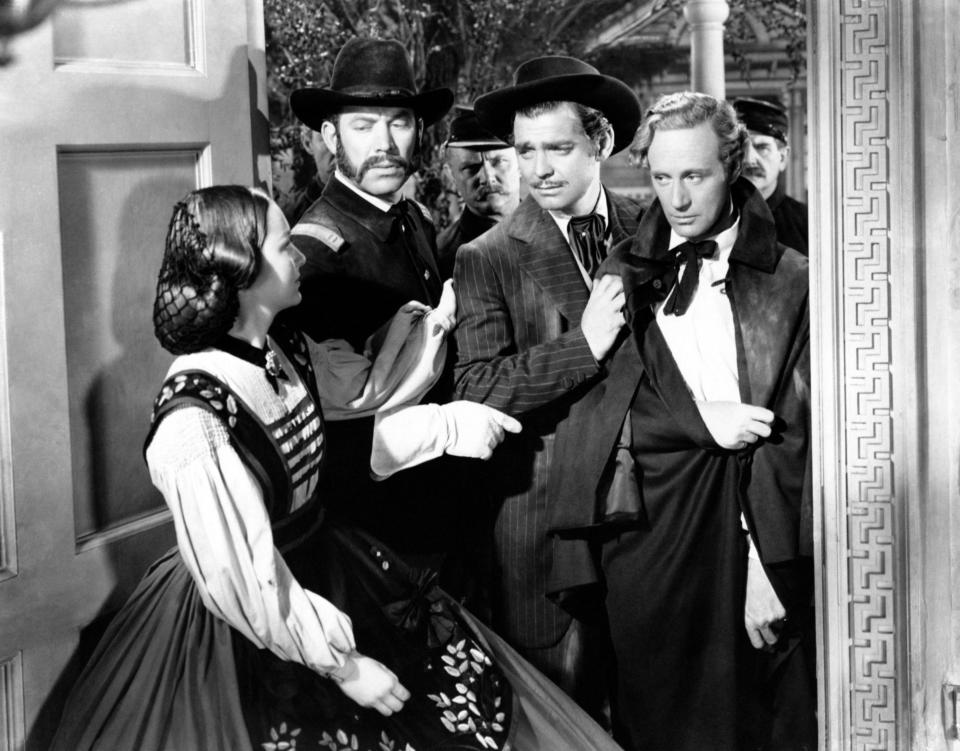 Actors Olivia De Havilland, Clark Gable and Leslie Howard, as Melanie Hamilton, Rhett Butler and Ashley Wilkes respectively in Gone with the Wind by Victor Fleming, in a scene from the movie. USA, 1939. (Photo by Mondadori via Getty Images)