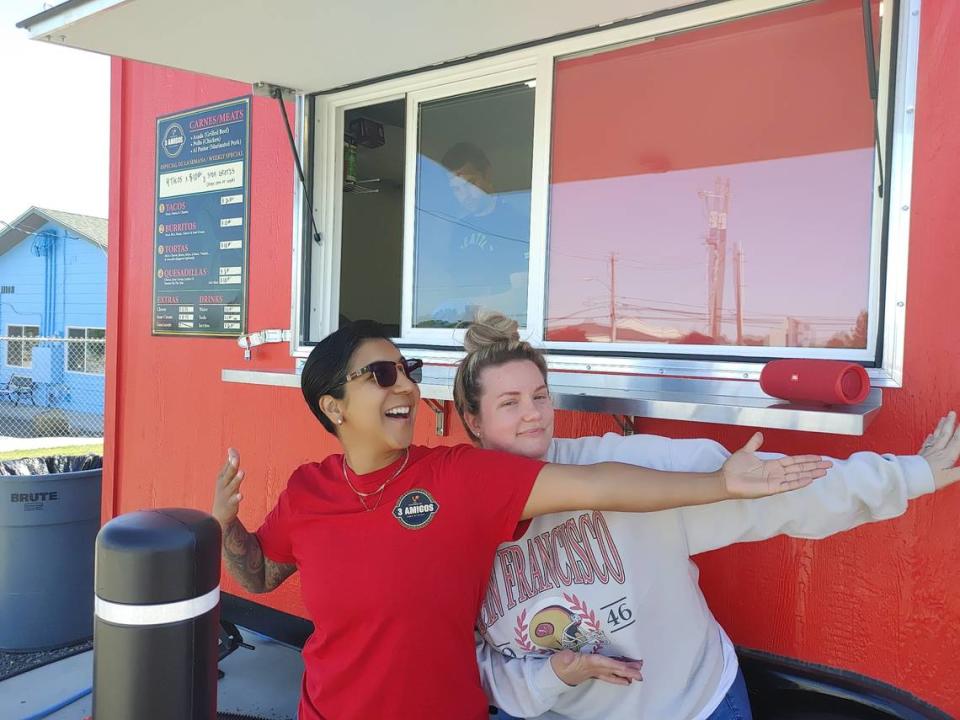 Partners Christy Ortiz and Whitney Garcia pose outside of Taqueria Los 3 Amigos, the second food truck to locate at Kennewick’s newest food truck plaza.