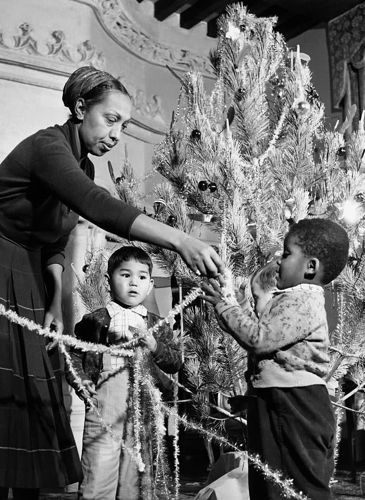 <p>The famed entertainer trims her tree with her children in her French chateau. Josephine Baker and her husband, Jo Bouillon, adopted 12 children together and lived in a countryside residence called Les Milandes. </p>