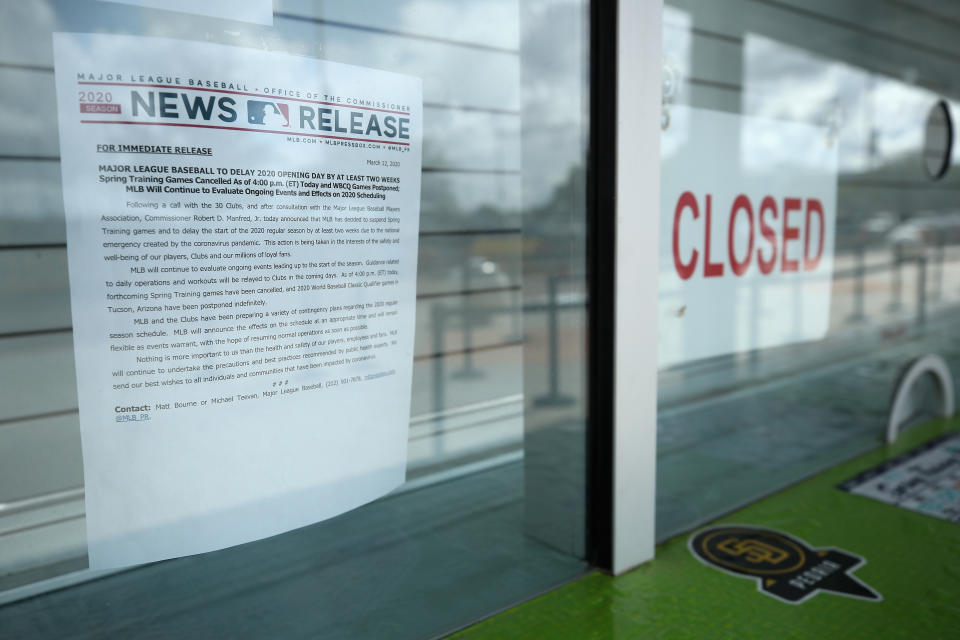 PEORIA, ARIZONA - MARCH 13: Closed signs and MLB news releases are displayed on box office windows outside of Peoria Stadium, home of the San Diego Padres and Seattle Mariners on March 13, 2020 in Peoria, Arizona. Major League Baseball cancelled spring training games and has delayed opening day by at least two weeks due to COVID-19. (Photo by Christian Petersen/Getty Images)