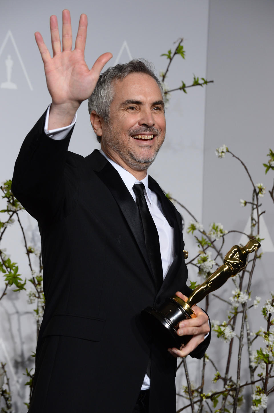 FILE - In this Sunday, March 2, 2014 file photo, Alfonso Cuaron poses in the press room with the award for best film editing for "Gravity" during the 86th Academy Awards at the Dolby Theatre, in Los Angeles. Cuaron and J.J. Abrams ("Lost," the "Star Trek" movies) are executive producers of the new NBC television series, "Believe," a drama about a child whose supernatural powers put her and the world at risk. (Photo by Jordan Strauss/Invision/AP, file)