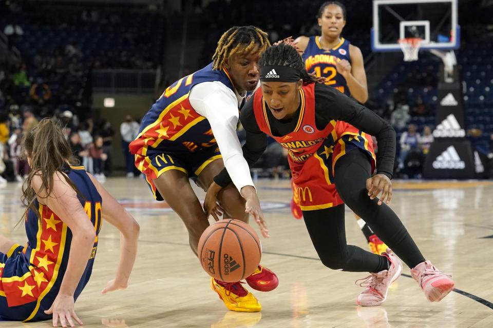 East girl's Talaysia Cooper, left, and West girl's Aaliyah Gayles battle for a loose ball in the first half of the McDonald's All-American Girls basketball game Tuesday, March 29, 2022, in Chicago. (AP Photo/Charles Rex Arbogast)