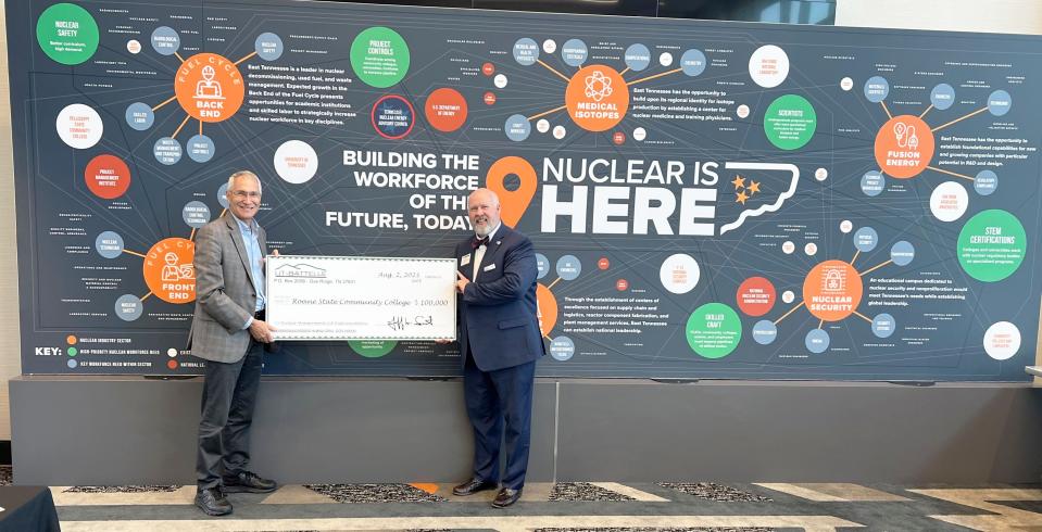 Jeff Smith, from left, interim president and CEO of UT-Battelle and interim ORNL director, presented a $100,000 check to Roane State Community College President Chris Whaley at the Nuclear Opportunities Workshop at the Airport Hilton.