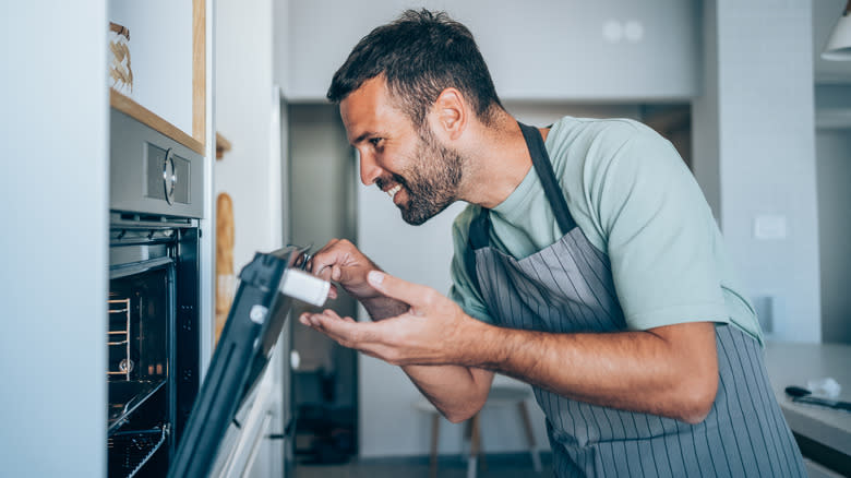 man opening oven