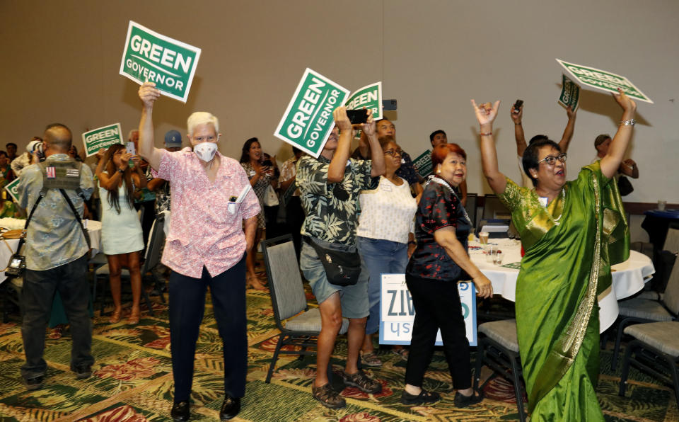 Democratic supporters react to election results at the Democratic Party headquarters, Tuesday, Nov. 8, 2022, in Honolulu. (AP Photo/Marco Garcia)