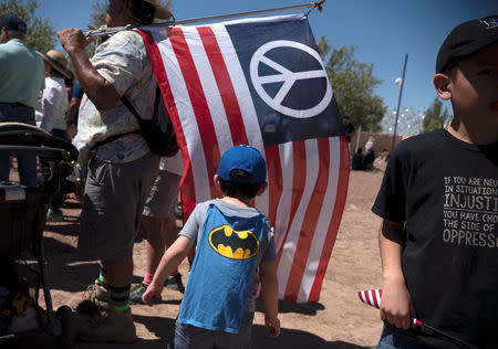 People participate in a protest against a recent U.S. immigration policy of separating children from their families when they enter the United States as undocumented immigrants, outside the Tornillo Tranit Centre, in Tornillo, Texas, U.S. June 17, 2018. REUTERS/Monica Lozano