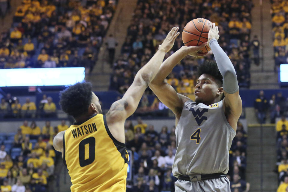 West Virginia guard Miles McBride (4) goes to make a shot as he is defended by Missouri guard Torrence Watson (0) during the second half of an NCAA college basketball game Saturday, Jan. 25, 2020, in Morgantown, W.Va. (AP Photo/Kathleen Batten)