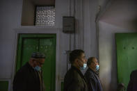 Uyghurs and other members of the faithful leave after prayer services at the Id Kah Mosque in Kashgar in western China's Xinjiang Uyghur Autonomous Region, as seen during a government organized visit for foreign journalists on April 19, 2021. Under the weight of official policies, the future of Islam appears precarious in Xinjiang, a remote region facing Central Asia in China's northwest corner. Outside observers say scores of mosques have been demolished, which Beijing denies, and locals say the number of worshippers is on the decline. (AP Photo/Mark Schiefelbein)