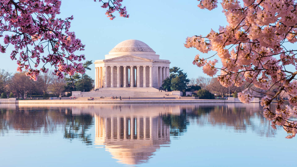 Sun rising illuminates the Jefferson Memorial and Tidal Basin.