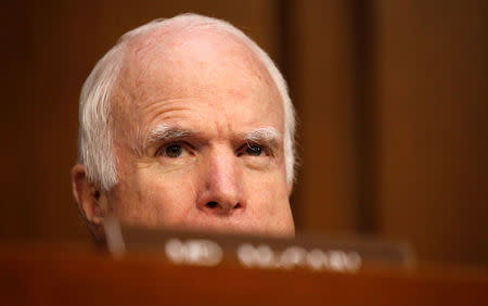 FILE PHOTO: Sen. John McCain (R-AZ), who is not on the committee, watches as former FBI Director James Comey testifies before a Senate Intelligence Committee hearing on Russia's alleged interference in the 2016 U.S. presidential election on Capitol Hill in Washington, U.S., June 8, 2017. REUTERS/Jonathan Ernst/File Photo