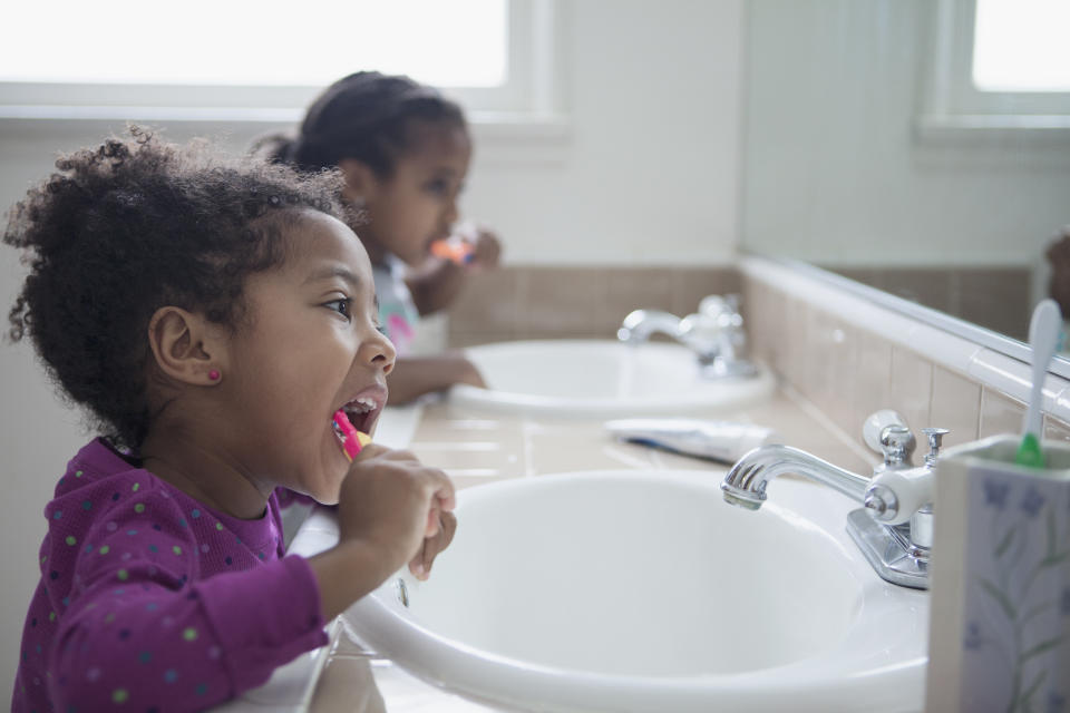 Little girls brushing their teeth