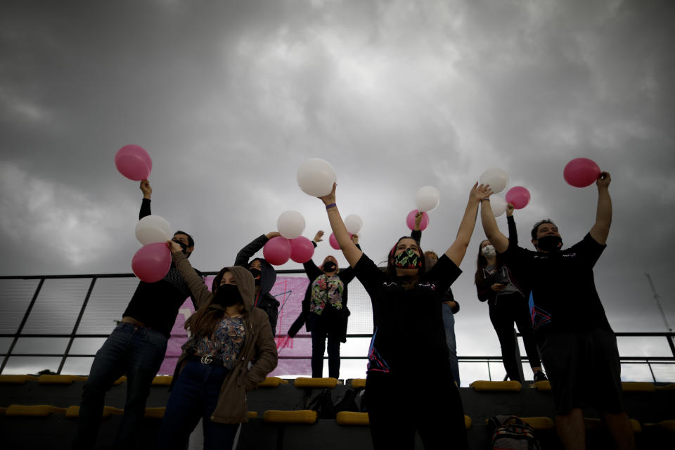 Vitarti Girl's Team fans cheer from the stands during the team's first race at the Oscar y Juan Galvez track in Buenos Aires, Argentina, Sunday, April 4, 2021. Finding sponsors has been difficult for the Vitarti Girl’s Team, the first and only all-female racing team in Argentina, and they only have enough funds in the budget for two more races. (AP Photo/Natacha Pisarenko)