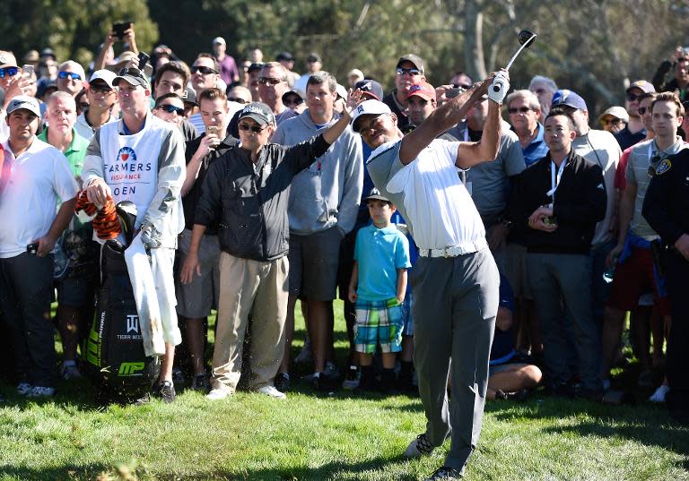 Tiger Woods plays his second shot from the rough on the 11th hole of the north course during the first round of the Farmers Insurance Open at Torrey Pines Golf Course on February 5, 2015 in La Jolla