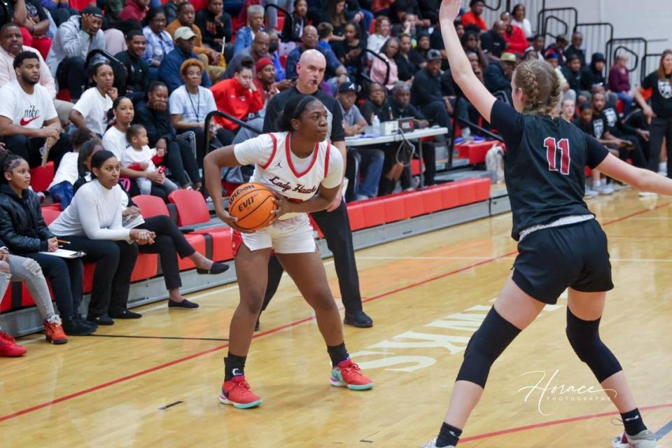 Hardaway High School girls basketball team member Jenaiya Hardy (white uniform) plays in a game during the 2023-24 season.