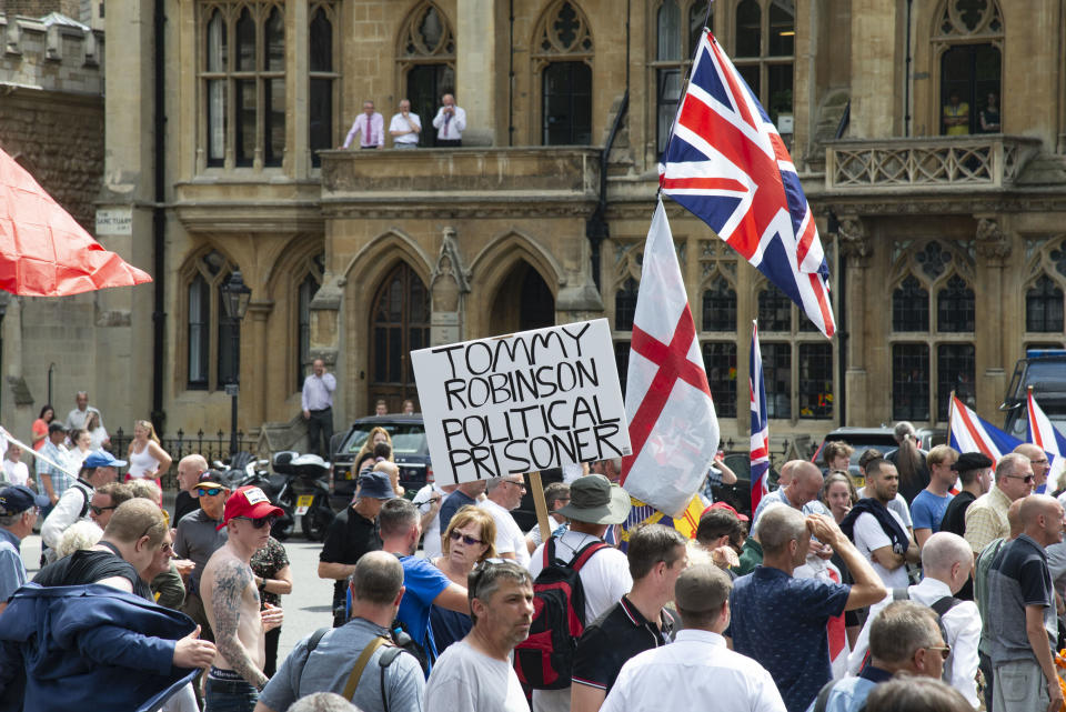 Staff from Westminster Abbey look on as supporters of Tommy Robinson real mame Stephen Yaxley - Lennon protest outside, after he was sentenced  to nine months in prison for contempt of court. He was found guilty of filming defendants accused of child sex offences outside Leeds Crown Court and live-streaming the footage on Facebook Live in May, 2018. (photo by Claire Doherty/In Pictures via Getty Images)