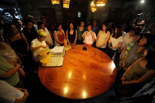Mary Anne Tayag, wife of artist and chef Claude Tayag, gives an introduction to customers before they start their lunch at the Bale Dutung in their house in Angeles, Pampanga, north of Manila. The couple hope to convert people at home and abroad to the secret cuisine wonders of the Philippines