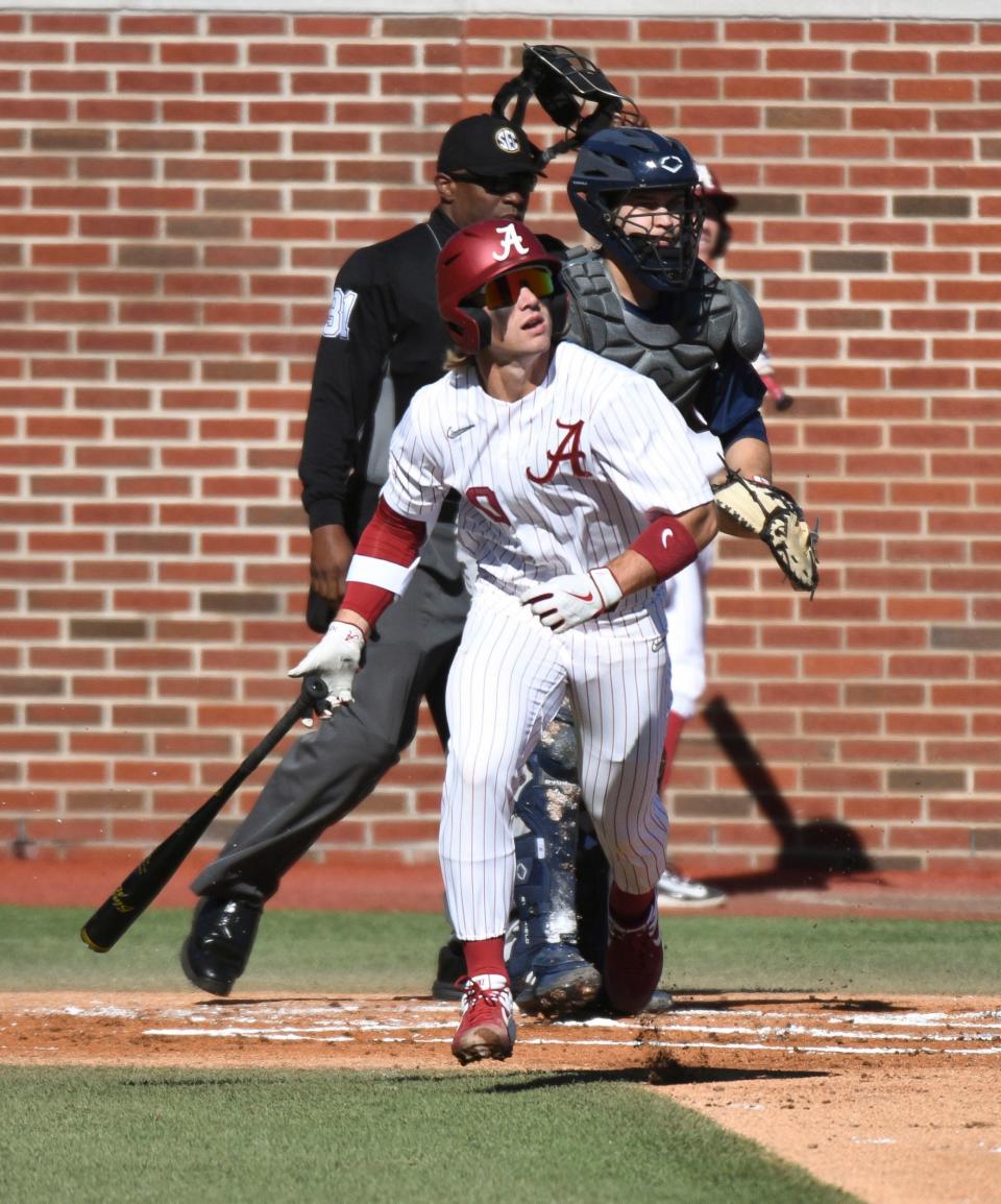 Feb 18, 2023; Bessemer, AL, USA;  Alabama hitter Jim Jarvis (10) looks to the outfield after connecting with a pitch. The Crimson Tide faced Richmond in the season-opening series.
