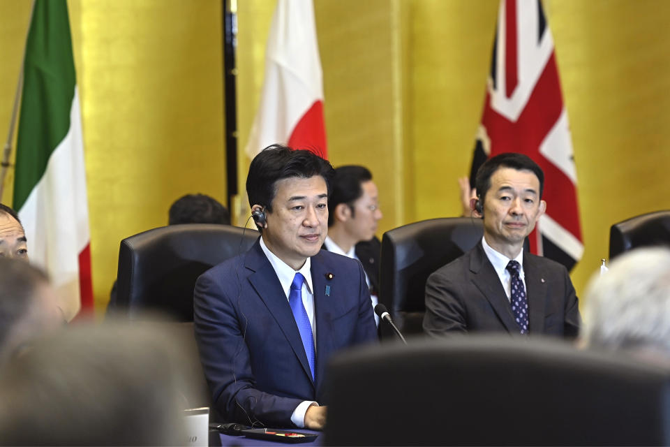Japanese Defense Minister Minoru Kihara, center, attends a trilateral meeting with Britain's Defense Minister Grant Shapps, not seen, Italy's Defense Minister Guido Crosetto, not seen, at the defense ministryThursday, Dec. 14, 2023, in Tokyo, Japan. (David Mareuil/Pool Photo via AP)