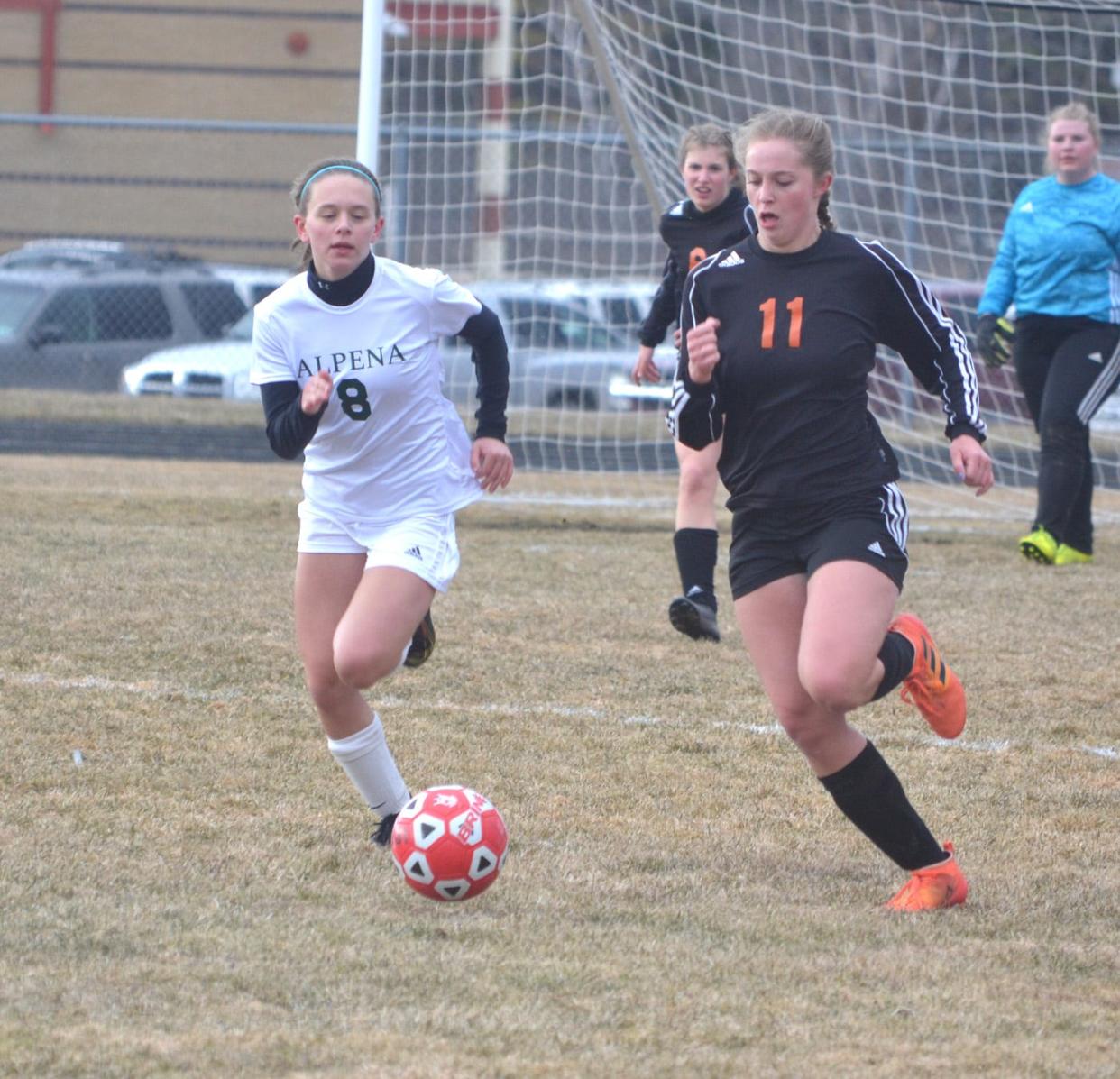 Cheboygan senior winger Camille Aper (11) chases down the ball during the first half of Wednesday's non-conference girls soccer home matchup against Alpena.