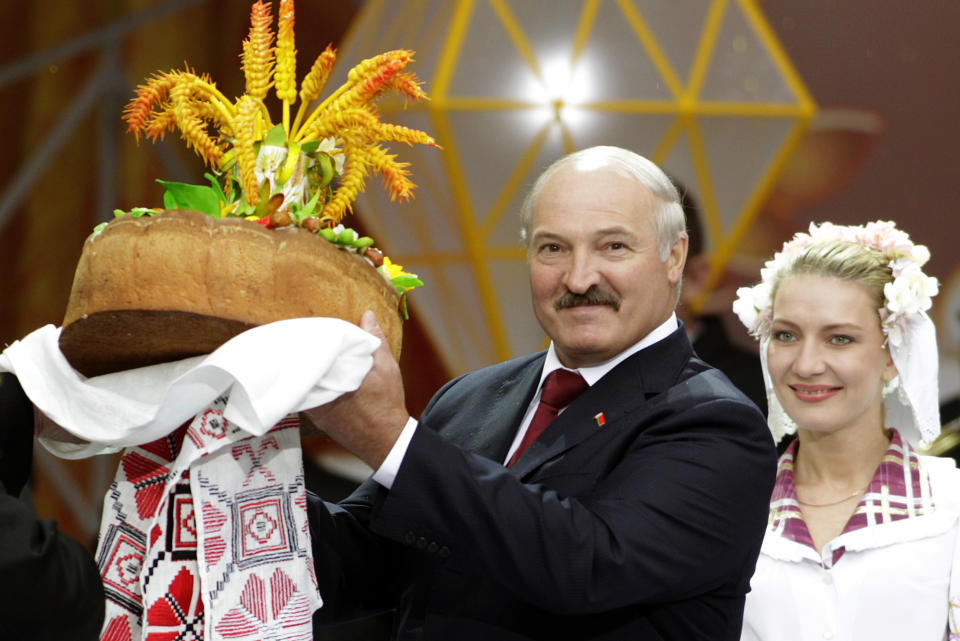 FILE In this file photo taken on Friday, Sept. 21, 2012, Belarusian President Alexander Lukashenko receives bread and salt during the Dazhynki harvest festival in the town of Gorki, some 270 km (168 miles) east of Minsk, Belarus. Belarus’ authoritarian President Alexander Lukashenko faces a perfect storm as he seeks a sixth term in the election held Sunday, Aug. 9, 2020 after 26 years in office. Mounting public discontent over the worsening economy and his government’s bungled handling of the coronavirus pandemic has fueled the largest opposition rallies since the Soviet collapse. (AP Photo/Vasily Fedosenko, Pool)