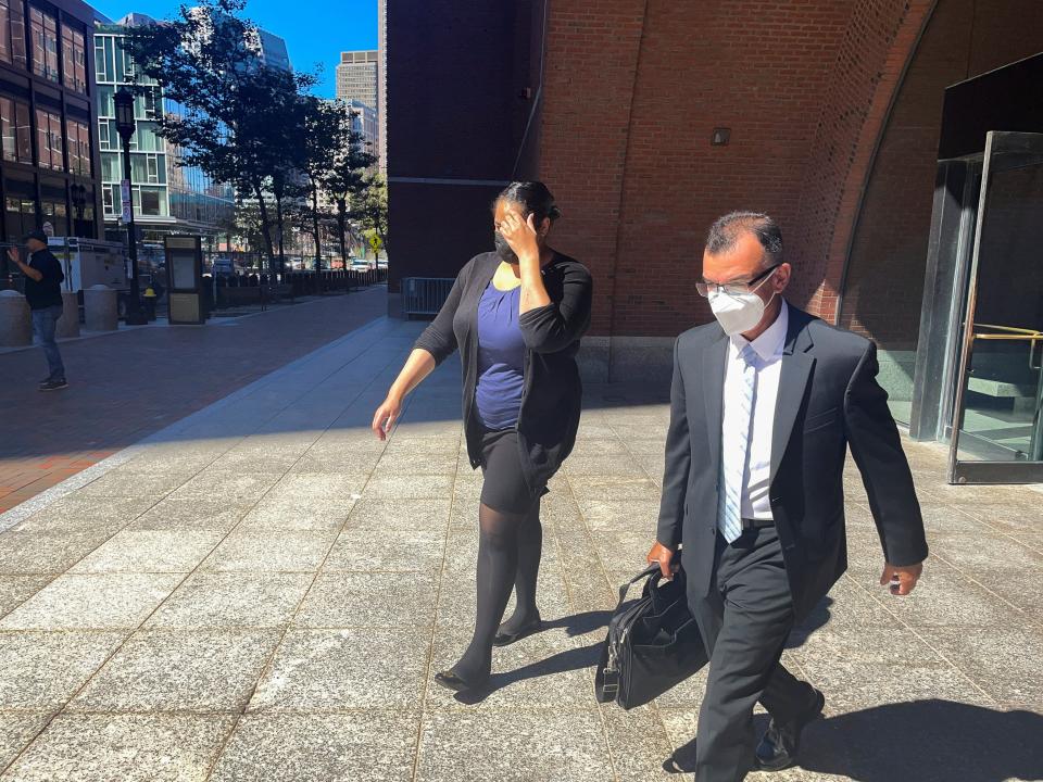 Mikaela Sanford, a former employee of Key Worldwide Foundation, exits the federal courthouse with her lawyer, Oscar Cruz, after testifying in the "Varsity Blues" college admissions scandal trial, in Boston, Massachusetts, U.S., September 20, 2021.