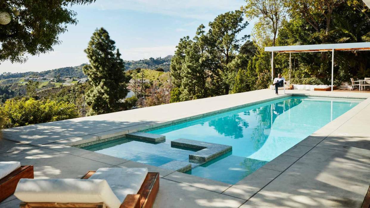 Man sitting next to the swimming pool