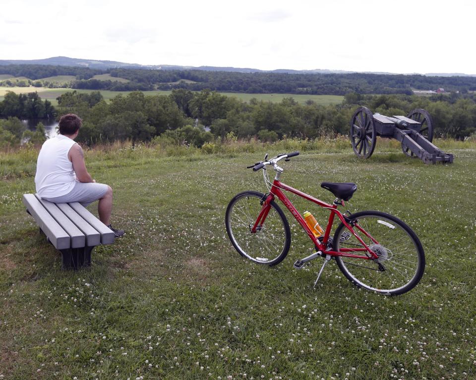 Victor Soto of Carlisle, N.Y., takes in the view on a bike tour of Saratoga National Historical Park in Stillwater, N.Y., on Monday, July 2, 2012. The bike tours offer an opportunity to learn about a battle considered one of the most significant in history, while getting a not-too-strenuous workout at the same time. (AP Photo/Mike Groll)