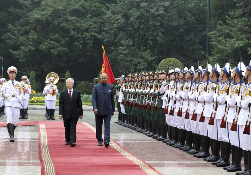 Indian President Ram Nath Kovind, right, and his Vietnamese counterpart Nguyen Phu Trong review an honor guard in Hanoi, Vietnam, Tuesday, Nov. 20, 2018. Kovind is on a three-day visit to Vietnam to boost trade, defense and security cooperation between the two countries. (Nguyen Van Diep/ Vietnam News Agency via AP)